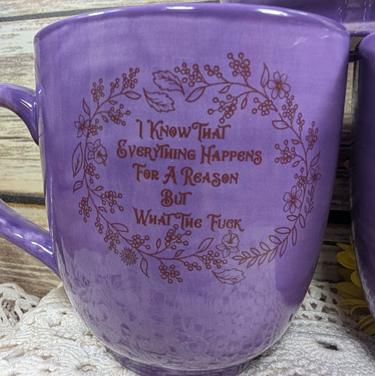 Purple mug with text and floral design on a wooden surface