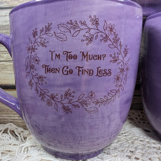 Purple mug with floral design and text on a textured surface