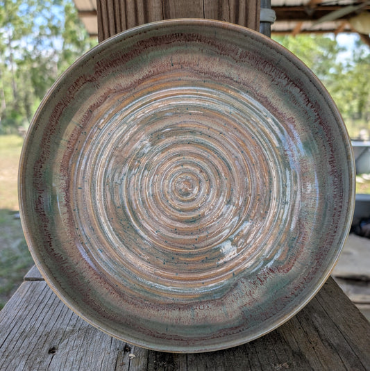 Ceramic serving dish with concentric circle pattern on a wooden surface