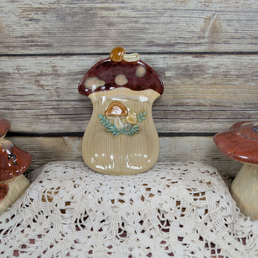 Ceramic mushroom decorative item on a lace tablecloth with a wooden background