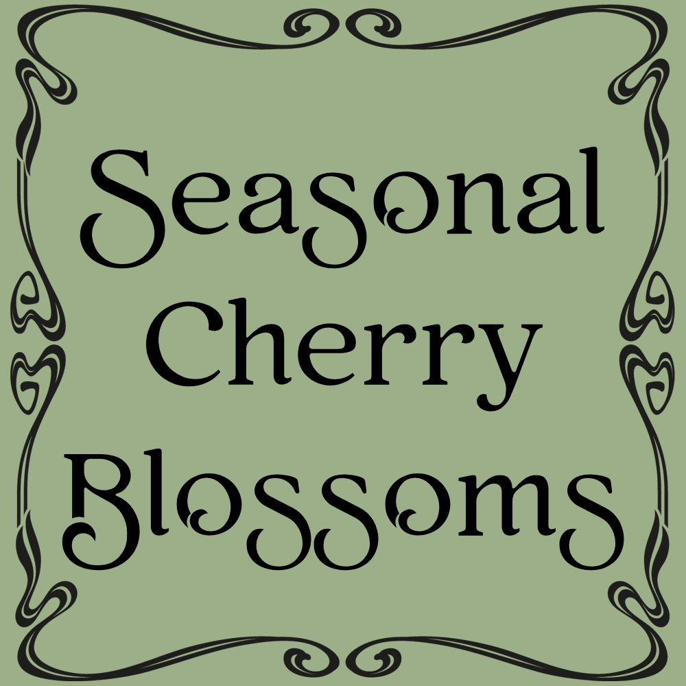 A selection of ceramic dishes on a stone stoop. The texture is one of cherries and cherry blossoms. Some are detail painted and some are a solid pale pink. 