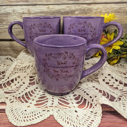 Three purple mugs with text on a lace doily
