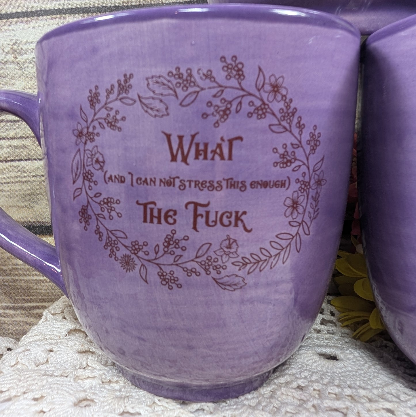 Purple mug with a humorous text design on a textured surface