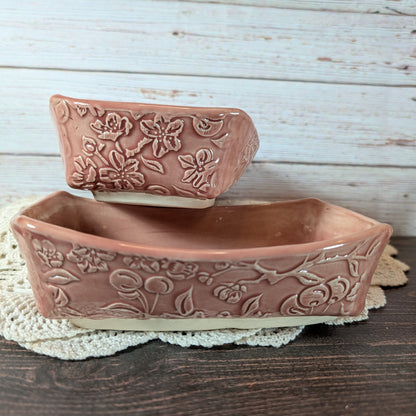 Two ceramic dishes with floral patterns on a wooden surface