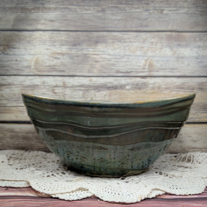 Ceramic bowl with wavy design on a wooden surface
