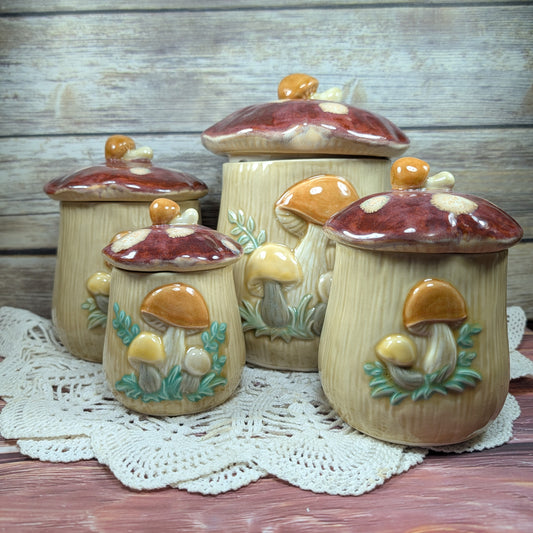 Set of four ceramic mushroom jars on a lace doily with a wooden background