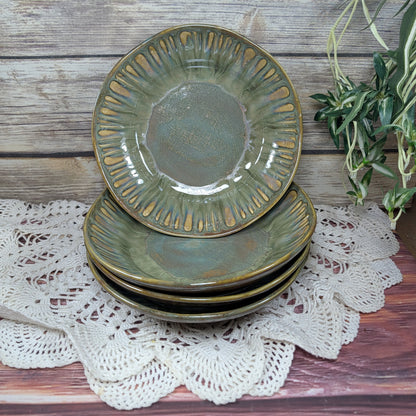 Stack of green ceramic bowls on a lace doily with a wooden background