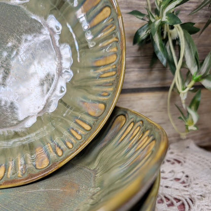 Stack of ceramic bowls with textured design on a wooden surface with a plant in the background