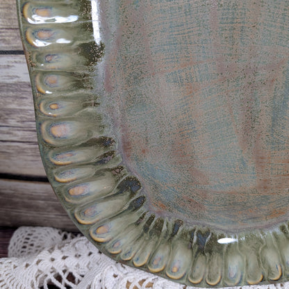 Close-up of a ceramic plate with textured edge and multicolored glaze.