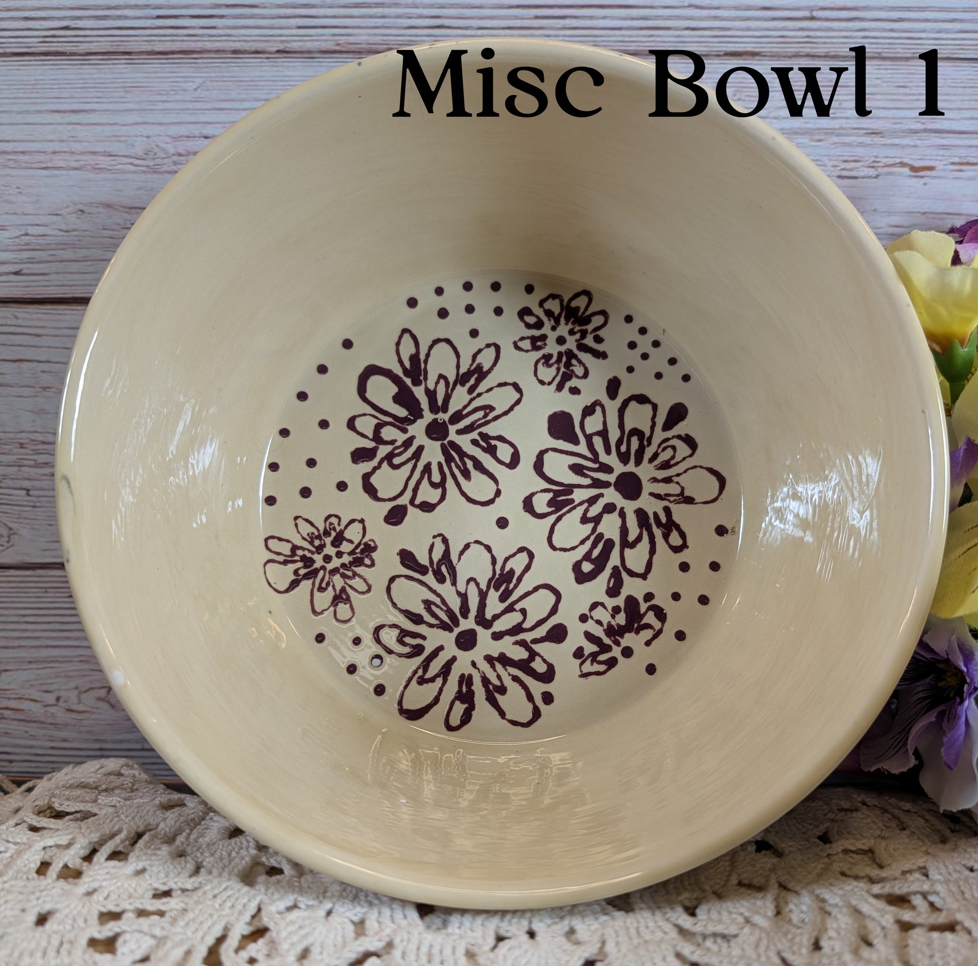 Beige bowl with floral pattern on a wooden surface
