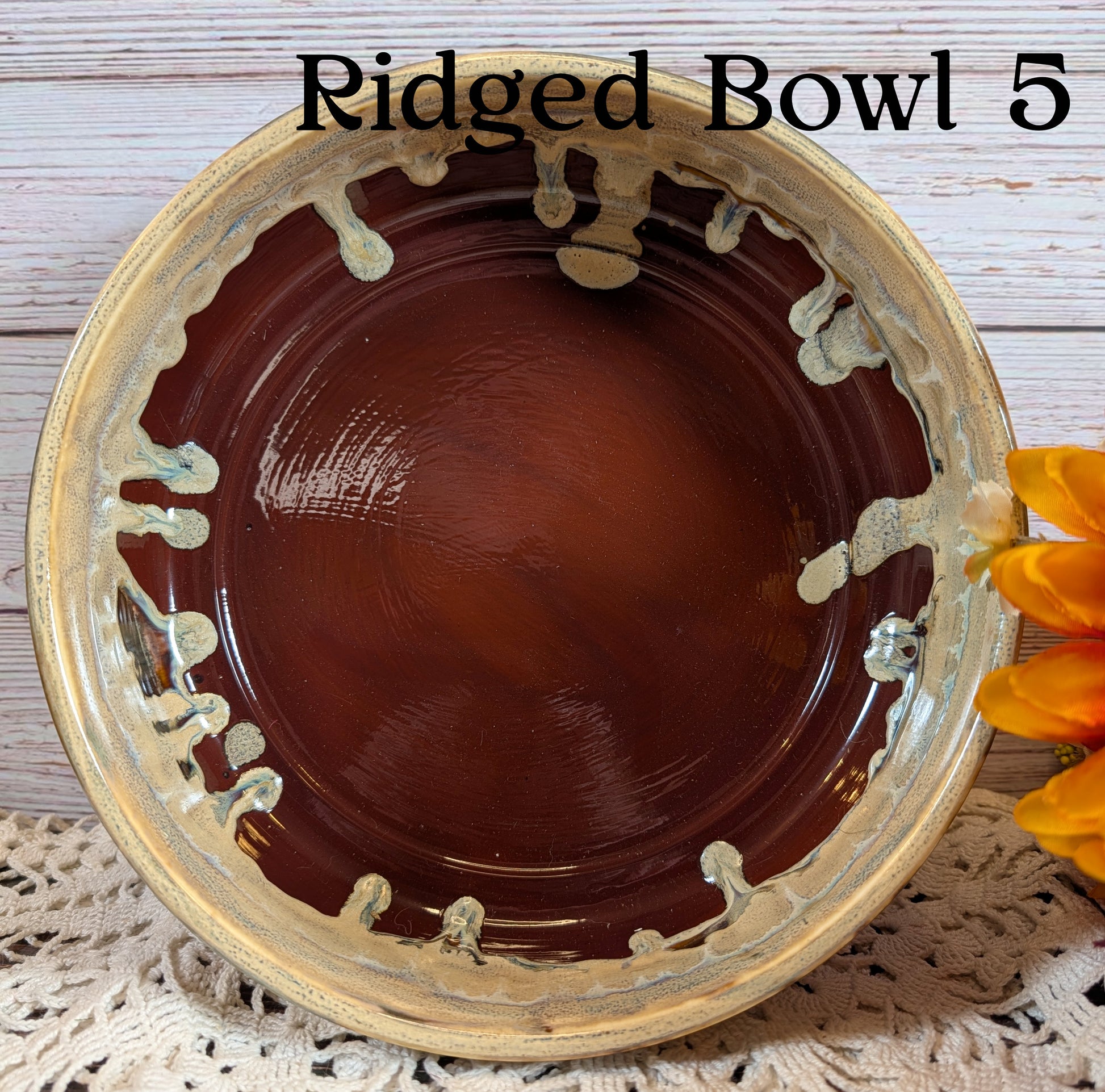 Ridged bowl with decorative edge on a textured surface with flowers