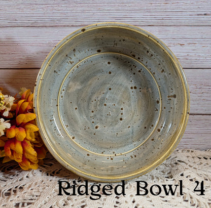 Ridged bowl on a wooden surface with decorative elements