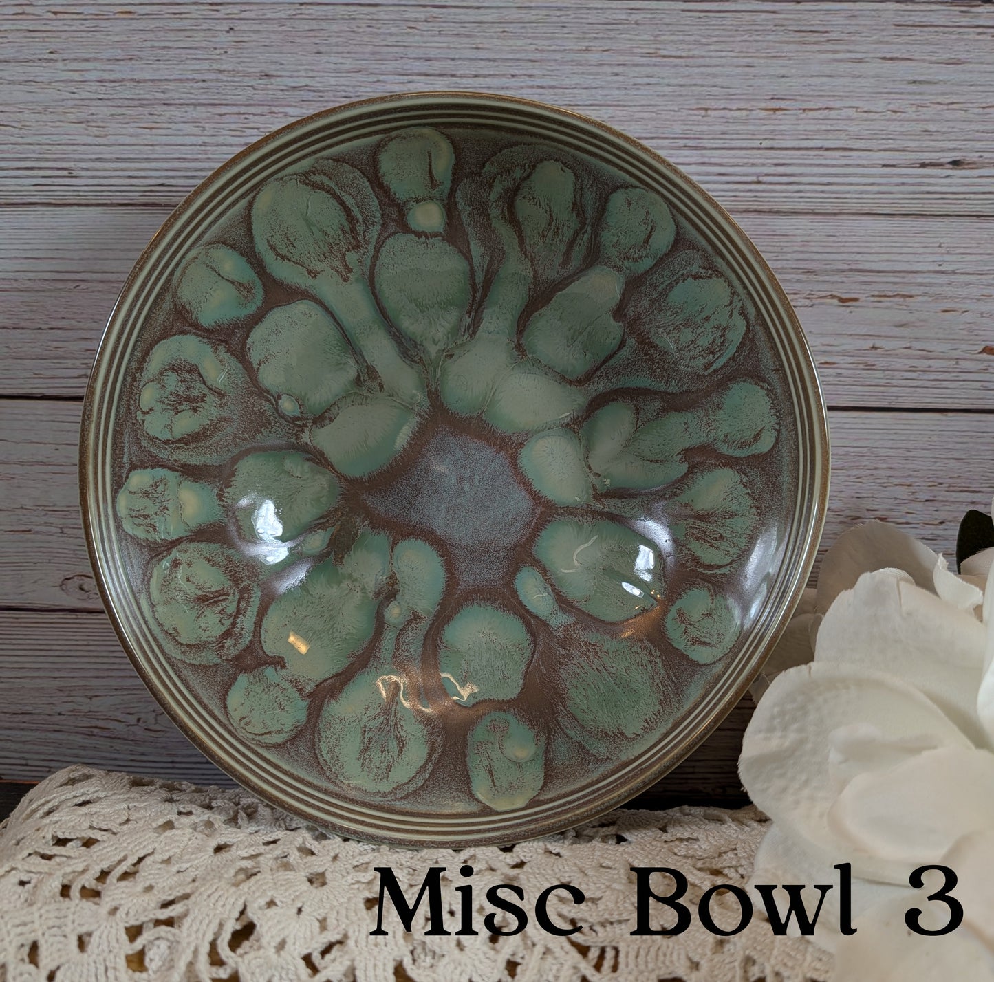 Ceramic bowl with green pattern on a wooden surface
