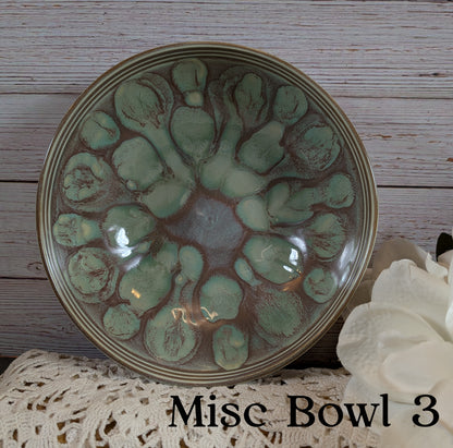 Ceramic bowl with green pattern on a wooden surface