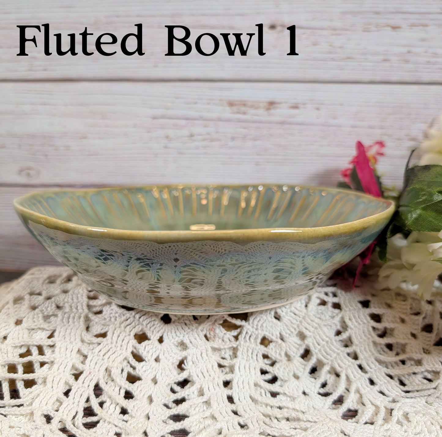 Green fluted ceramic bowl on a lace tablecloth with a wooden background