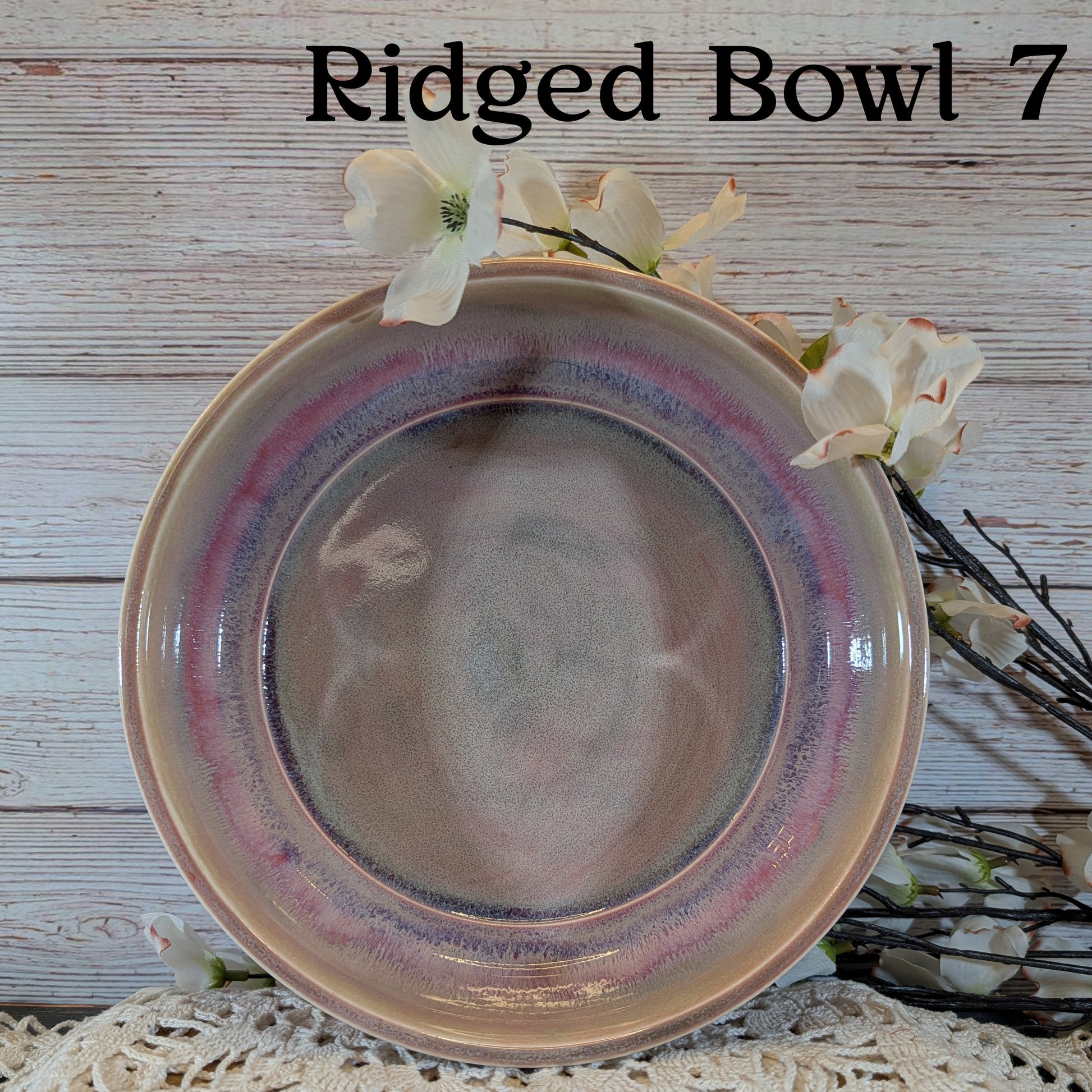 Pink and gray ceramic bowl with a textured surface on a wooden background